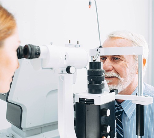 Senior Man Getting Eye Exam At Clinic