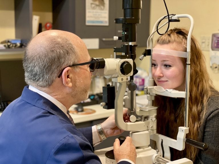 Dr. Steven Levin performing a medical eye exam at Levin Eye Care Center in Whiting, Northwest Indiana, highlighting full-scope optometry career opportunities.